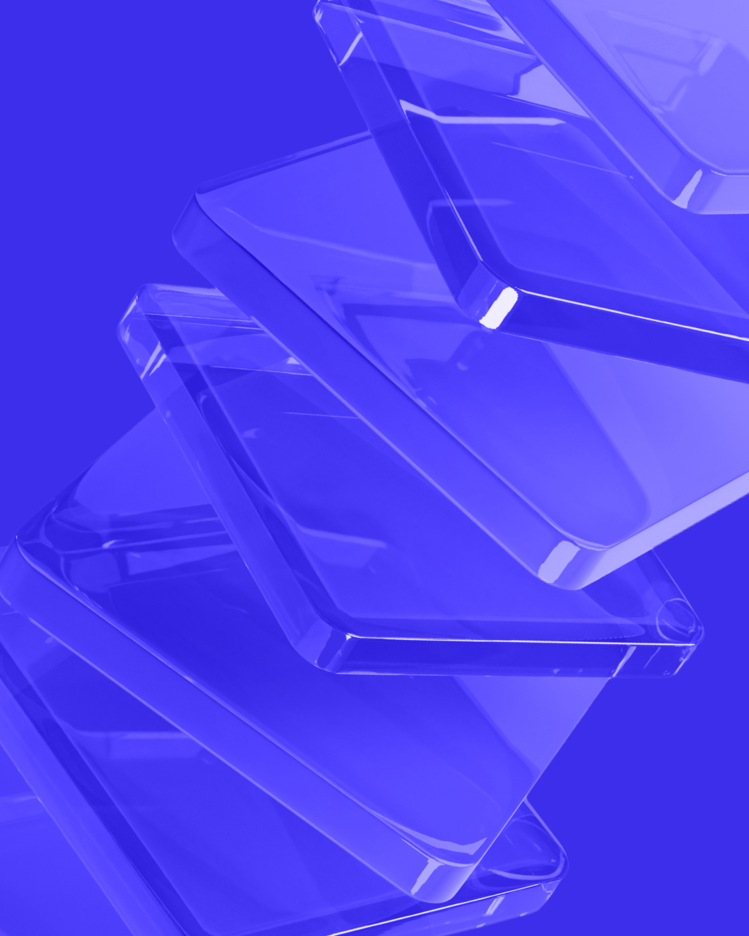 Close-up of several transparent, slightly overlapping glass-like rectangular blocks arranged diagonally on a solid blue background.
